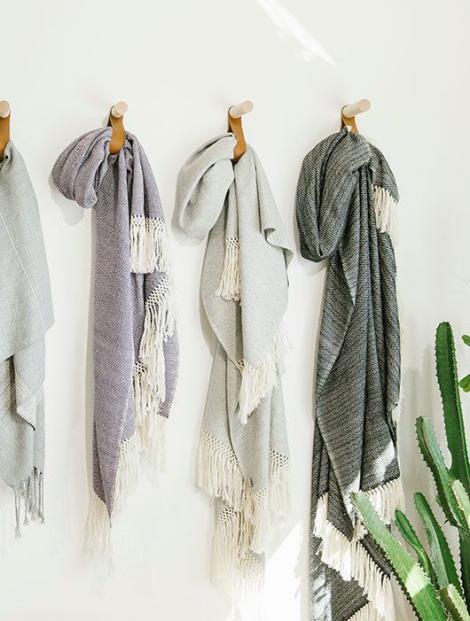Display throw blankets on the wall so they can stop taking up a whole shelf in your linen closet_